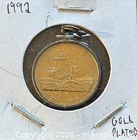 Frontal view of mounted coin within holder