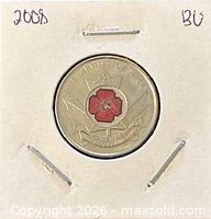 Coin in holder reverse side showing colour poppy design