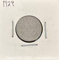 Reverse of 1929 Canada five cents showing denomination and maple leaves