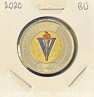 Reverse of the coin in holder showing coloured V design and dates
