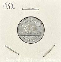 Front view of coin flip with reverse visible and handwritten year