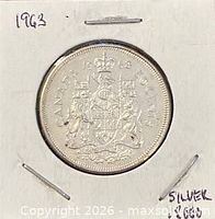 Coin in cardboard holder, reverse side showing Canadian coat of arms and date 1963