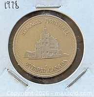 Obverse of 1978 St. Marys Trade Dollar showing Town Hall