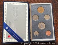 Closed presentation set showing coins and certificate