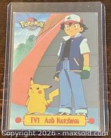 Front view of Ash Ketchum trading card in sleeve