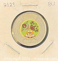 Coin in cardboard flip showing colourized reverse design