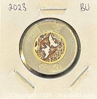 Reverse of 2023 colour Riopelle twoonie in holder