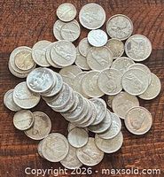 Pile and stack of assorted Canadian silver dimes and quarters