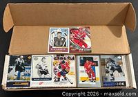 Open box showing several featured hockey cards on top and the bulk of cards beneath