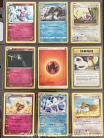 Front view of nine Pokémon cards in binder sheet