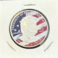 Obverse showing portrait of Donald Trump with U.S. flag background and inscriptions