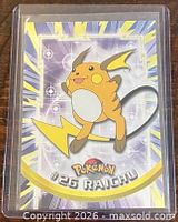 Front of Raichu #26 Topps trading card in sleeve