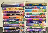 Two vertical stacks of Disney VHS tapes showing all 20 titles