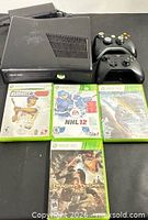 Console, controllers and four games displayed