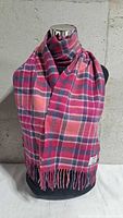 Front view of multicoloured cashmere scarf on mannequin, showing plaid pattern and fringe