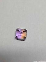 Square emerald-cut ametrine showing colour zoning in diffuse light