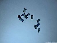 Group of nine rectangular baguette-cut sapphires on white background