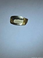 Top view of golden heliodor showing cushion cut facets and color