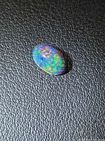 Top view of oval Ethiopian black opal showing full pinfire pattern