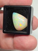 Front view of pear-shaped Ethiopian opal in display box