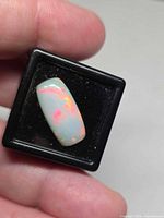 Front view of rectangular Ethiopian opal showing play of color