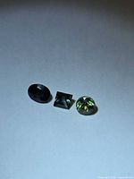 All three loose sapphires on white background showing size and cuts