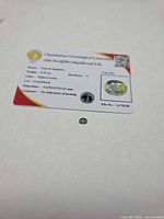 Sapphire and front of Chanthaburi Gemological Laboratory card