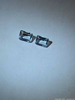 Front view of the two emerald-cut aquamarines
