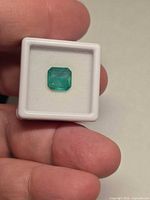 Emerald in gem case front view showing octagon cut