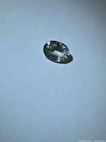 Loose oval cut platinum blue sapphire on white background