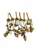 Group of 12 brass electric window candle lights showing brackets, candle sleeves and wiring.