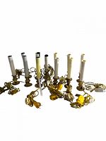 Group of 14 brass-tone electric candle lights with cords visible