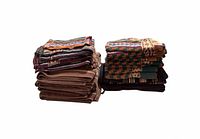Two stacks of patterned and solid brown towels showing quantity and style