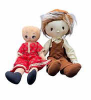 Front view of both cloth dolls seated side by side