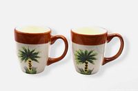 Front view of two Summer Palm mugs showing design and handles