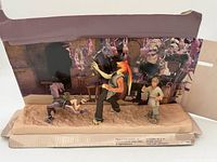 Front view of full Mos Espa Encounter diorama with three figures and backdrop