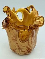 Front angled view showing amber and brown swirled Murano glass bowl with ruffled rim