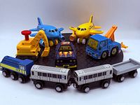 Group shot showing all toy vehicles and wooden train cars