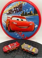 Frisbee front and two Lightning McQueen cars overview