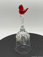 Front view showing red bird topper and crystal bell body
