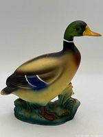 Left side front view of duck figurine showing colors and base