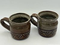 Front view of both stoneware mugs showing exterior glaze and pattern