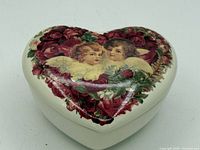 Lid view showing cherub and rose graphic