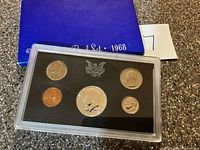 Front view of sealed proof set showing five coins in case