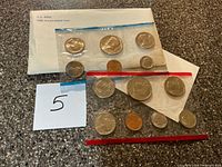 Full view of envelope and both sealed coin packs showing all coins