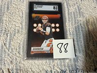 Front of encased 2023 Panini Zenith Joe Burrow card with grade label
