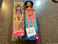 Front view of both boxed Barbie dolls