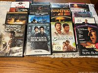 All sixteen DVD cases laid out on table