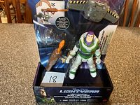 Front view of boxed Buzz Lightyear figure showing accessories and branding