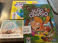 Three boxed items: Paint Vortex kit, Hi Ho Cherry-O game, Puzzle game machine